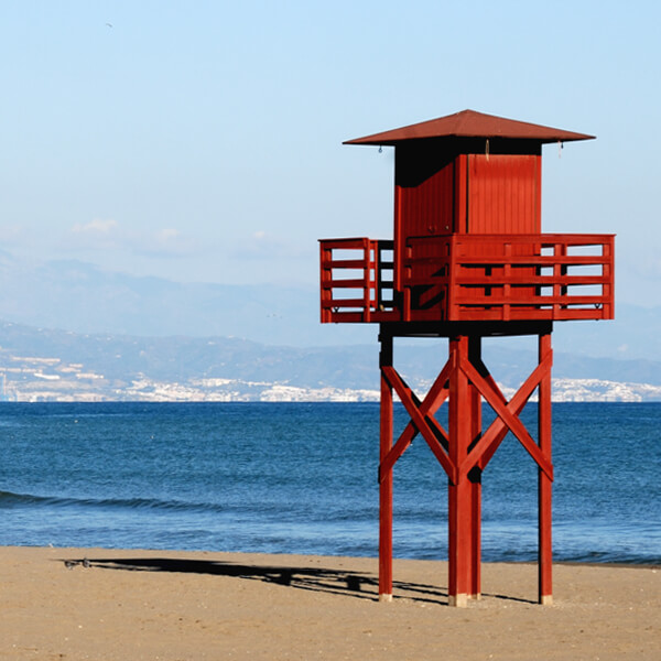 T&iacute;pica torre de vig&iacute;a de madera roja para los socorristas en la playa